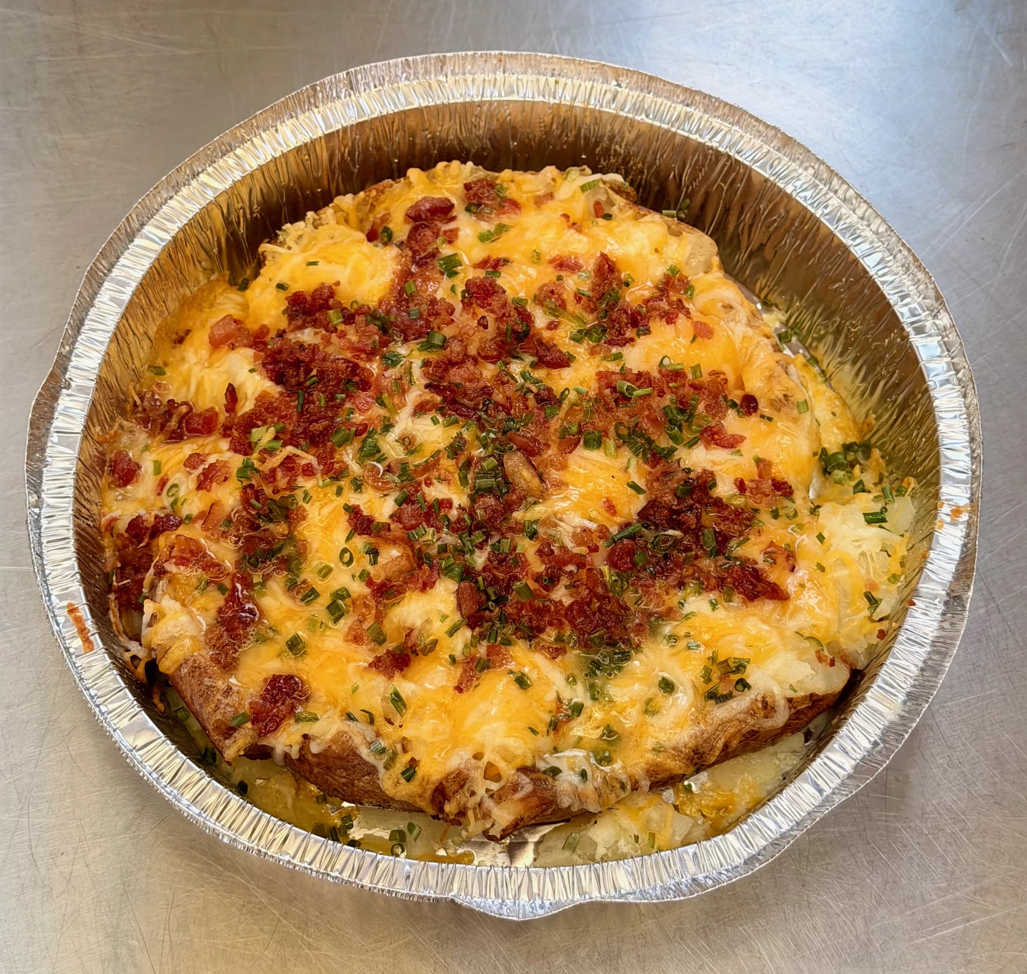 A CHUBBYS jumbo potato covered with melted cheese, bacon, and chives